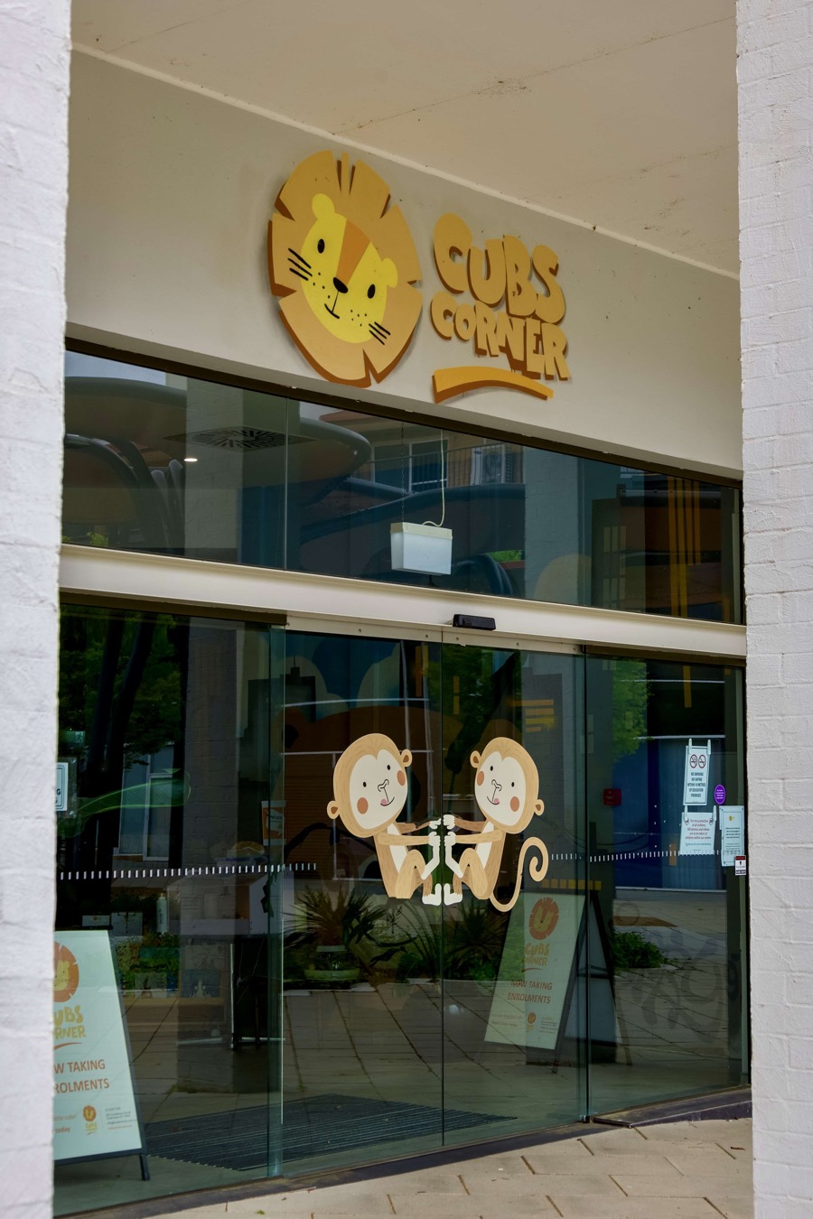 The glass entry doors of Cubs Corner with the lion logo above