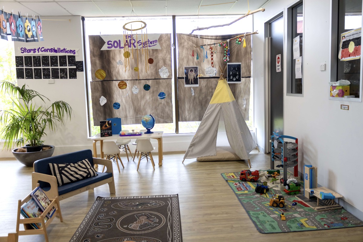 A room at Cubs Corner with a tipi, a solar system display and soft furnishings